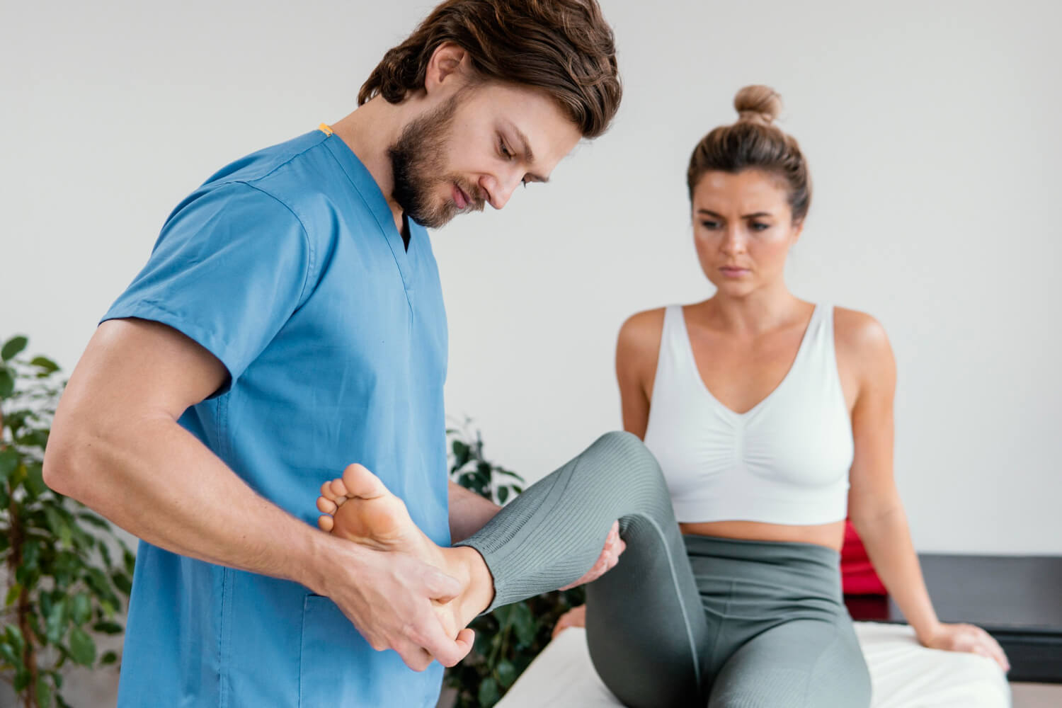 Doctor holding the ankle of the patient