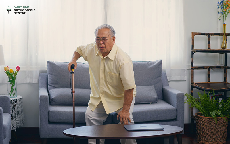 Elderly man struggling with joint pain.