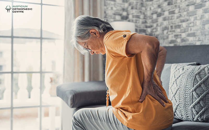 Elderly woman feeling lower back pain
